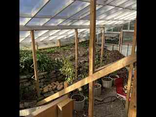 Greenhouse is attached to the house with walk out from the basement.