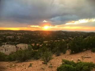 Setting for the house at sunset. Looking down from the ridge behind house.