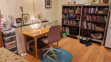 In the living room we have a second desk and desk chair and a large part of our books, all at your disposal of course. On the right of the book case is a tall fridge freezer combo.