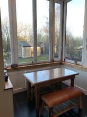 Large modern kitchen with ceiling to wall windows overlooking garden