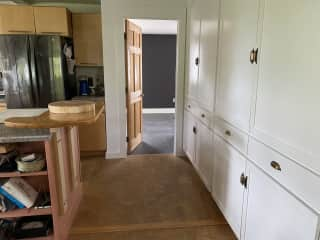 View from the dining area through the kitchen to the door to the guest suite