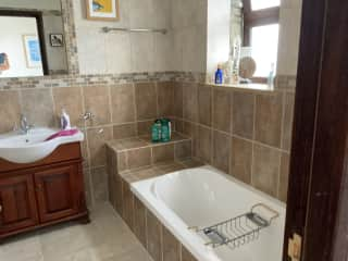 En-suite with bath and shower over