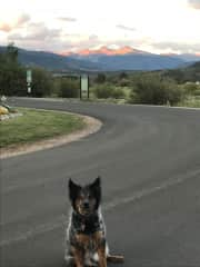 Linus outside house, looking toward Lake Dillon, 14ers Grays and Torrys lit by setting sun