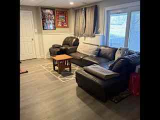 Finished basement living area with tv