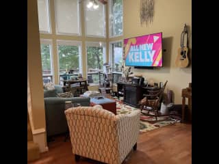Family room. Good for TV watching, reading books, watching an electric fire, and looking out the windows to the forest.
