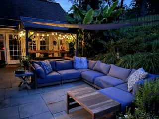 Outdoor living room alongside pool