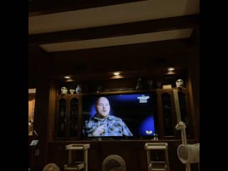 Tv room with leather seating and wood-burning fireplace