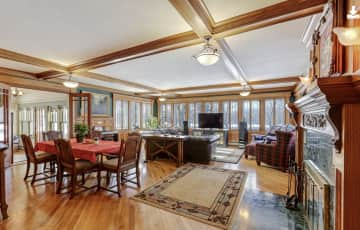 Living room and dining room. Windows overlook river.