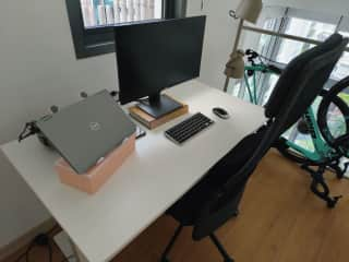 Home office in loft. The desk is a manually adjusted standing desk. The desktop monitor, laptop stand, mouse and keyboard can be used by the sitter