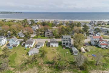 Our house: Grey, 3 floors, small garage to right. It will not fit a car, we keep snowblower and summer furniture stored here. You can see the beach is across the street.