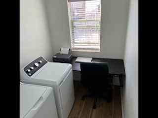 Work space w/standing desk & BT printer + paper. In laundry room… weird, I know but we use the desk to fold loads of laundry