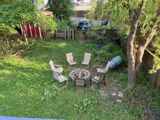 Back yard, featuring a firepit, and tumbling composter.