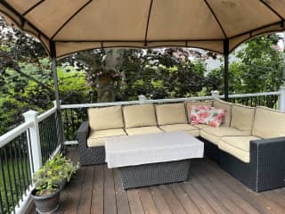 covered sitting area on back deck.