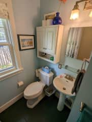 The upstairs bathroom has a tub/shower combo and a pedestal sink.