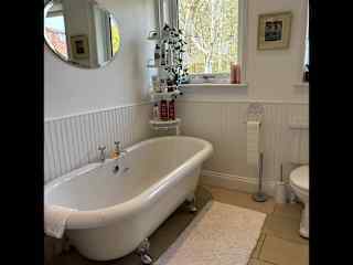 Bathroom. There is a walk-in shower unit as well as this bath.