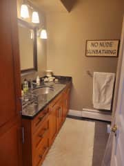 Bathroom with lots of cupboard space and full tub shower.