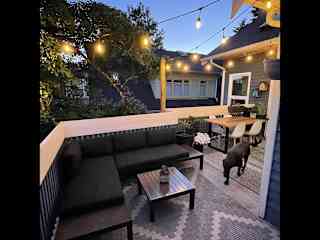 Our main patio with an outdoor dining and living space, nestled amongst the trees.