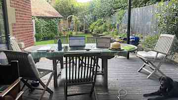 View from sitting room into garden. Table under cover.
