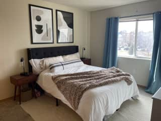 Queen bed in primary bedroom. Nightstands have touch lamps w/power outlets