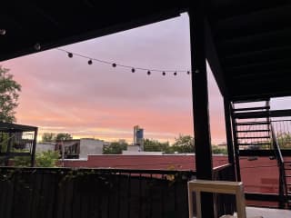 Another back patio view during summer.  There is a BBQ for use as well, a table and 4 chairs, and 2 rocking chairs on the patio.