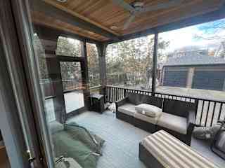 Screened in porch with view of backyard & garage (ping-pong is in garage)