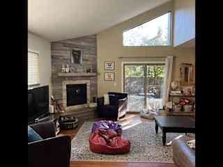 Living room with smart TV and gas fireplace.
