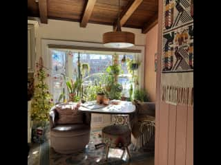 Kitchen nook with comfy chairs and lots of plants