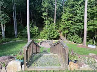 Outdoor hardscaping and fire pit accessible for use. Firewood on site.