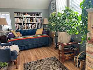 Sunroom with twin bed and trundle below. Half bath attached.