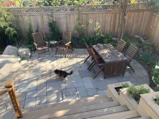 Patio with seating (taken in early spring before everything is in full bloom- much more green and flower filled in summer)