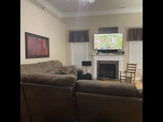 Living room with large family couch and TV, gas fireplace does not work (sorry)