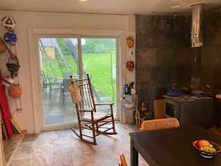 Kitchen that looks out onto our lush front and back yards both through airy, large, sliding glass doors.