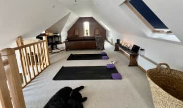 Loft Area yoga/meditation area and supplies.  Yoga mats are stored in baskets @ right.