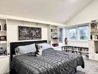 The second floor loft-style bedroom has a king-sized bed (shown here with Rico) and its own full bathroom.  There is another full bathroom on the first floor.