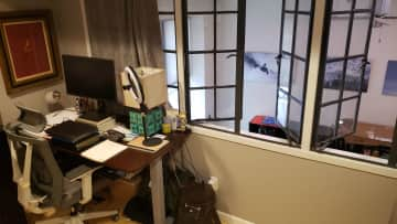 Reserve angle in second bedroom, looking out through vintage interior windows down to the first floor below.