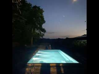 Pool at night before electric hard pool cover closed