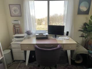 Desk space with monitor, printer, and paper shredder