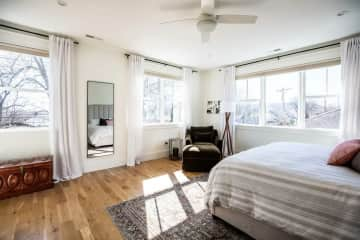 Master bedroom with a king-size bed and blackout shades