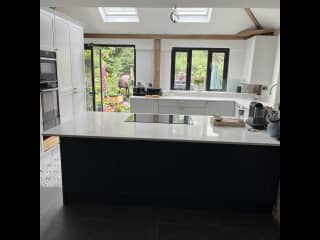 Kitchen with breakfast bar. Electric oven, hob, microwave, dishwasher, washing machine, coffee machine.