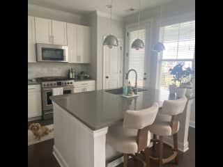 Kitchen with gas stove and stainless steel appliances. Coffee maker, air fryer, crockpot, non stick cookware.