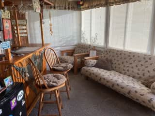 Sunroom and tiki bar, entry from dining room, includes entrance to backyard and grilling area.