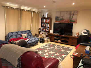 Front lounge with large screen TV and futon that can also be used as a bed