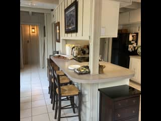 Kitchen counter with bar stools.