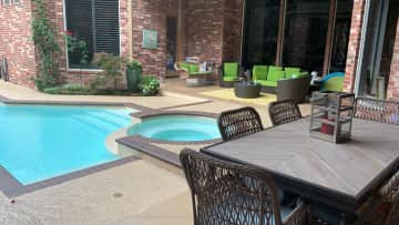 Outdoor dining and sitting area by the pool.