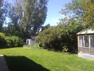 Large yard with veggie garden, bbq and dinning area. We use the wooden out building as a yoga/exercise room with rock-climbing hang board.