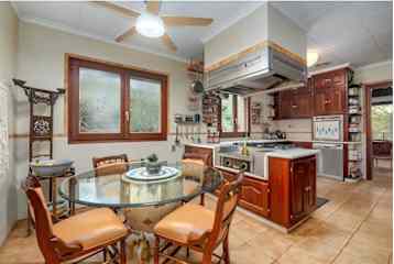 Large, well equipped kitchen with gas stove cooking.