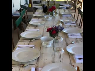 farm table on back porch set for company