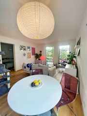 Dining table with view of living room, and through to the master bedroom