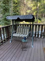 Porch swing off the front door. There's also a little table and 2 chairs for enjoying your morning coffee.