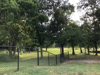 Fenced backyard overlooking treelined pasture land